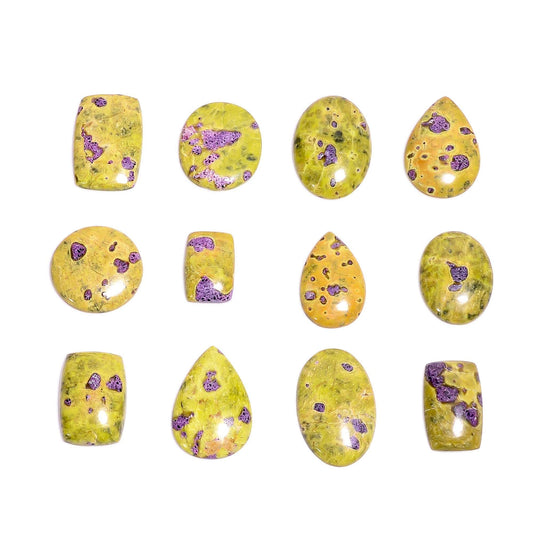 Natural atlantisite stichtite gemstone cabochons ā close up purple pink spots on yellow green serpentine base mixed shapes