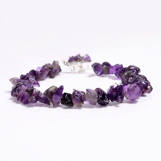 Purple beaded bracelet on a white background