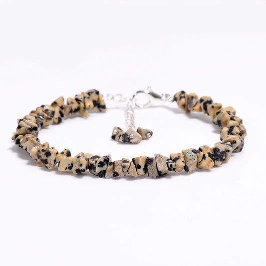 Beige and black beaded bracelet on a white background