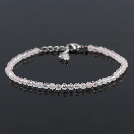 Pink rose quartz crystal bracelet full length on black background β clean product adjustable chain shot