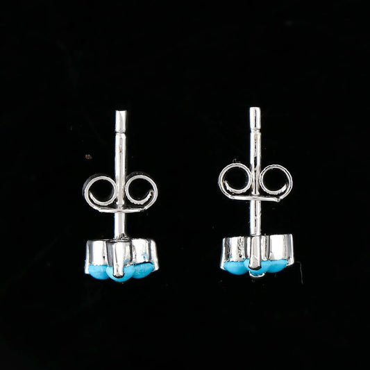 Real turquoise stud earrings with 3-stone flower design ā close up