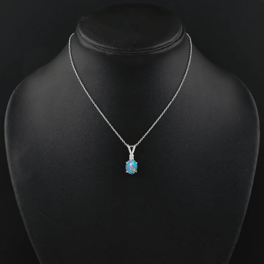 Silver necklace with a blue pendant on a black mannequin bust