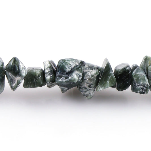 Close-up of green stone beads on a white background