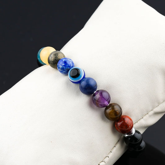 Multicolored beaded bracelet on a white surface with a black background