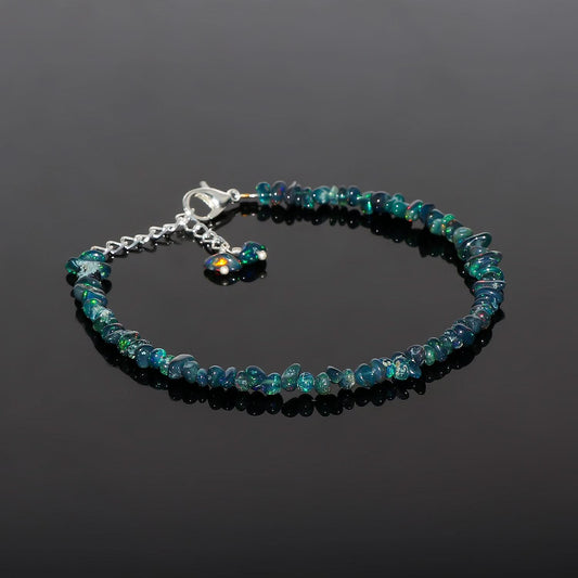 Blue beaded bracelet on a black background