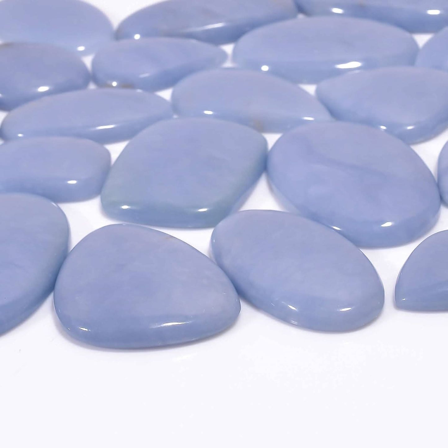 Close-up of light blue stones on a white background