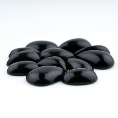 Black stones arranged in a circular pattern on a white background
