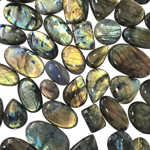 Labradorite gemstone cabochons in hand – size reference 20-35mm A+ quality pieces