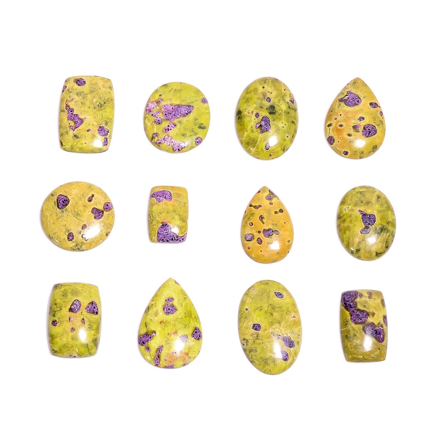 Natural atlantisite stichtite gemstone cabochons – close up purple pink spots on yellow green serpentine base mixed shapes