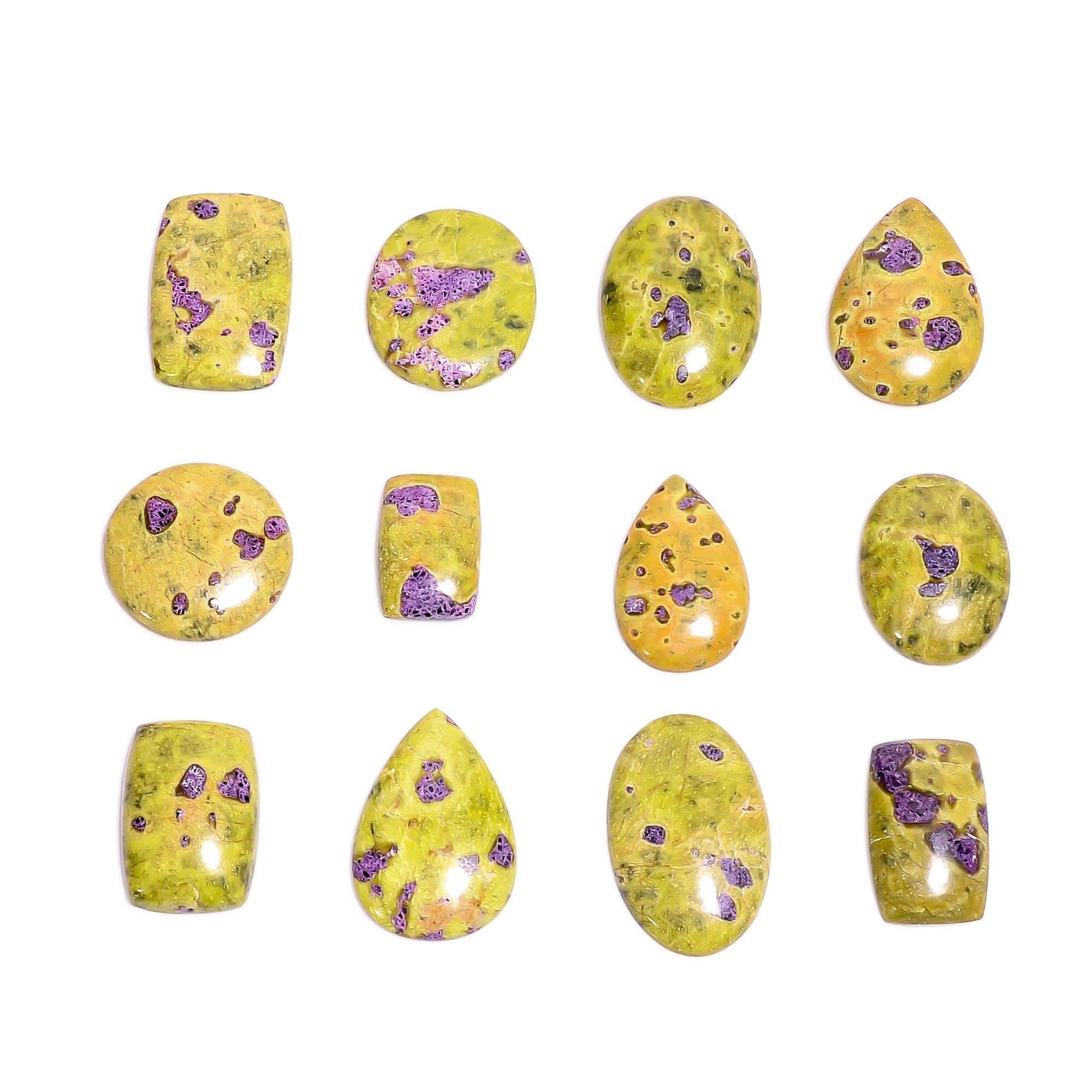 Natural atlantisite stichtite gemstone cabochons – close up purple pink spots on yellow green serpentine base mixed shapes