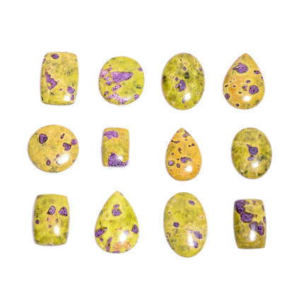 Natural atlantisite stichtite gemstone cabochons – close up purple pink spots on yellow green serpentine base mixed shapes