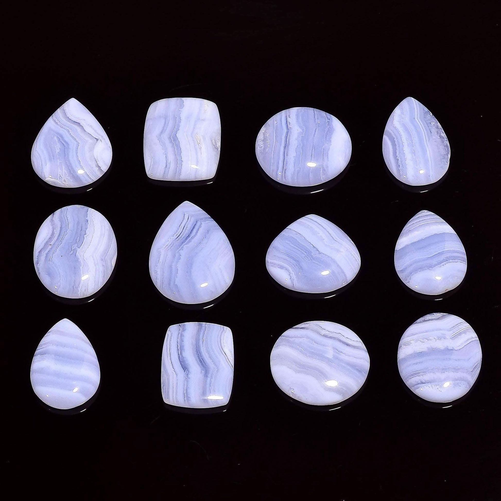 Natural blue lace agate gemstone cabochons mixed shapes on white background – individual pieces