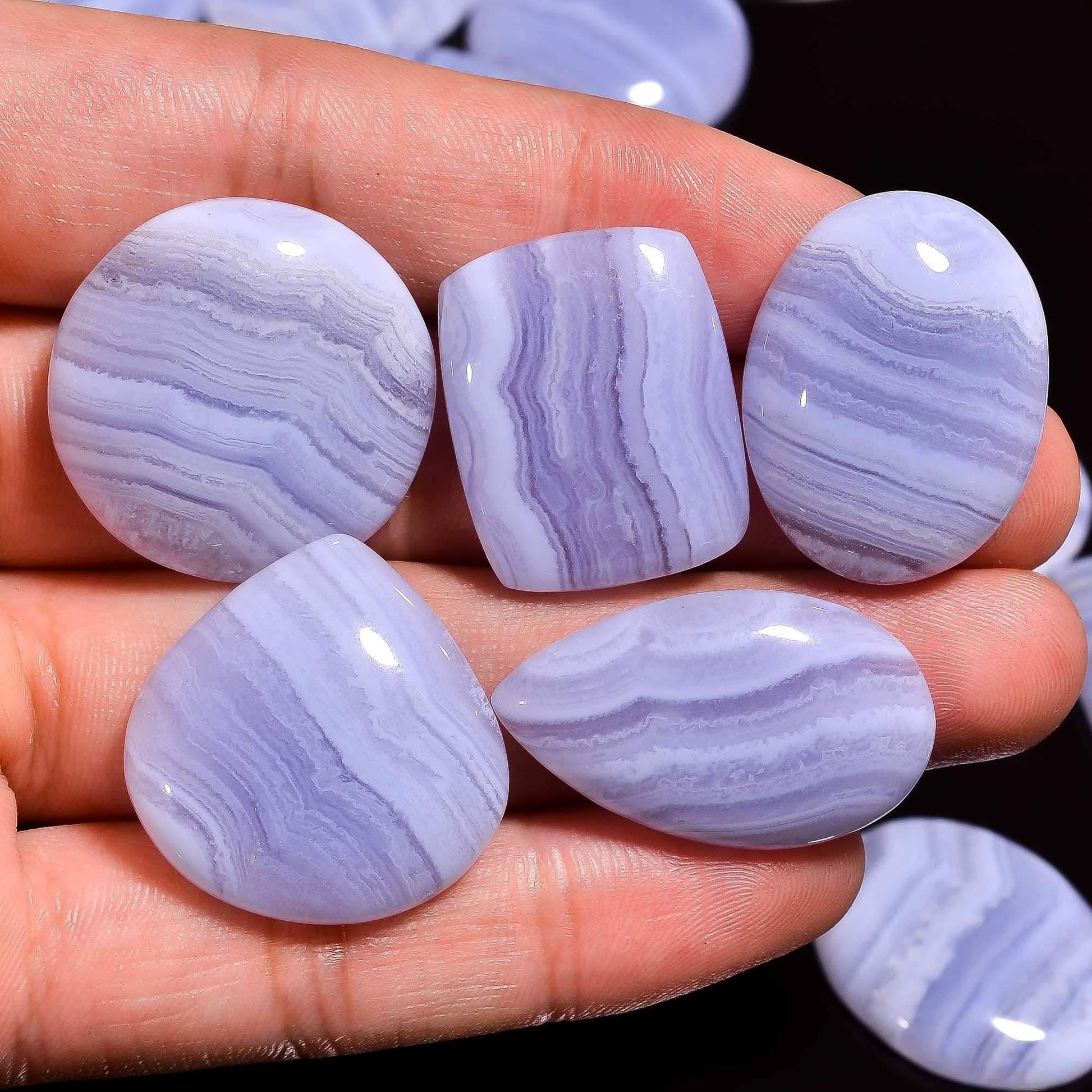 Blue lace agate stones on a hand
