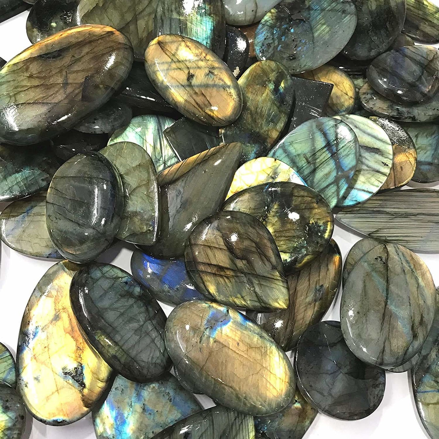 Collection of labradorite stones with iridescent patterns on a white background