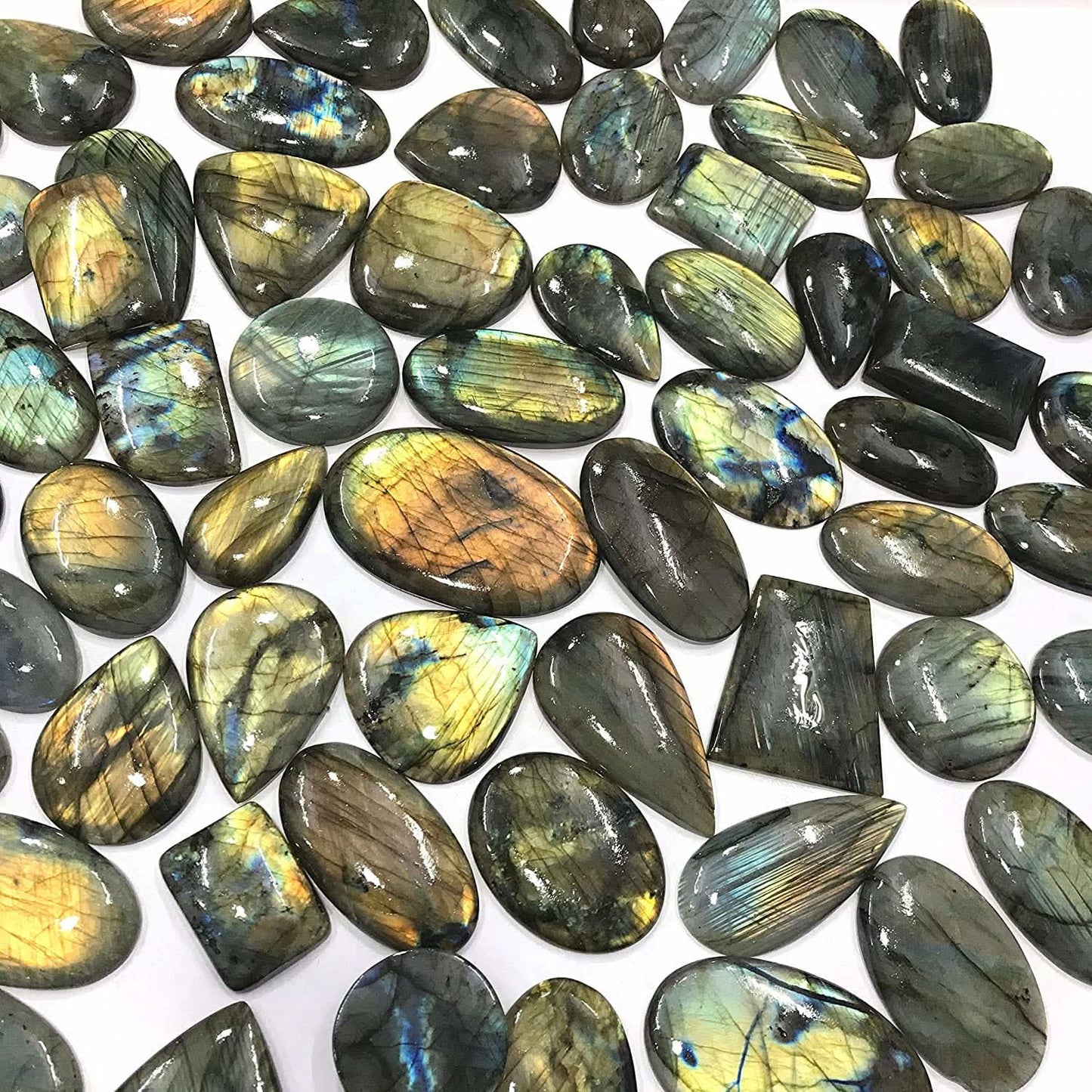 Natural labradorite gemstone cabochons showing vivid blue green gold labradorescence – individual pieces