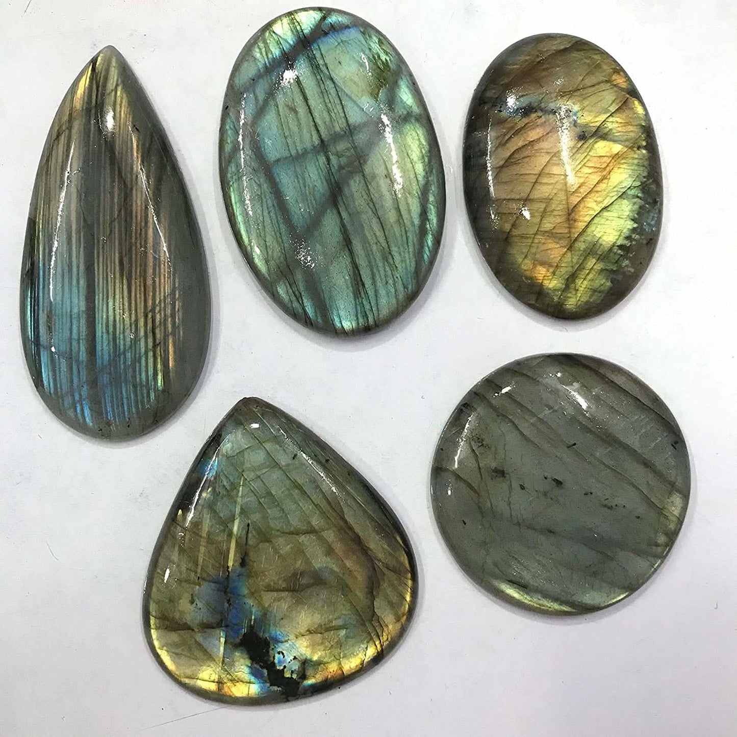 Five Labradorite stones of various shapes on a white background
