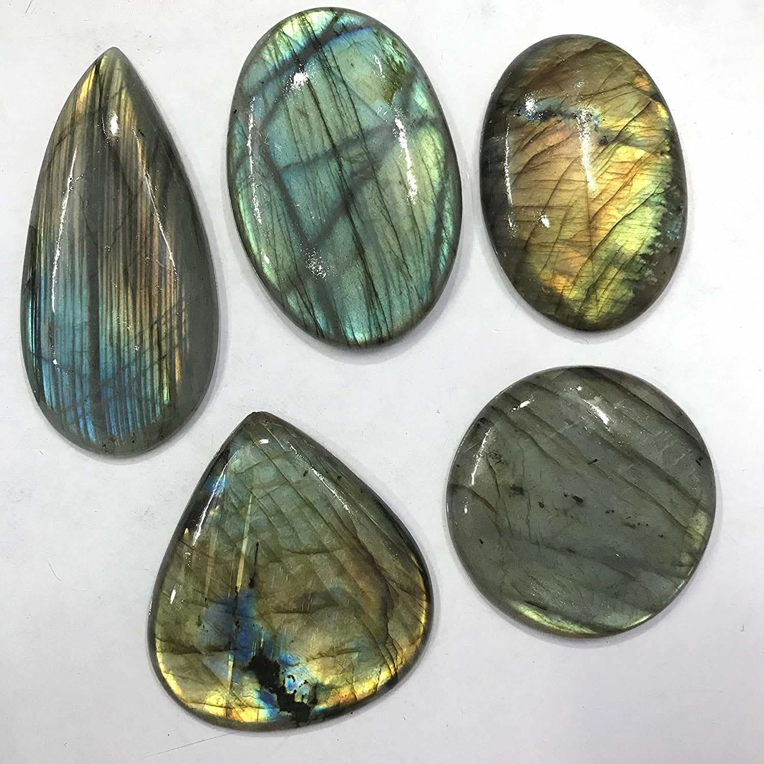 Five Labradorite stones of various shapes on a white background