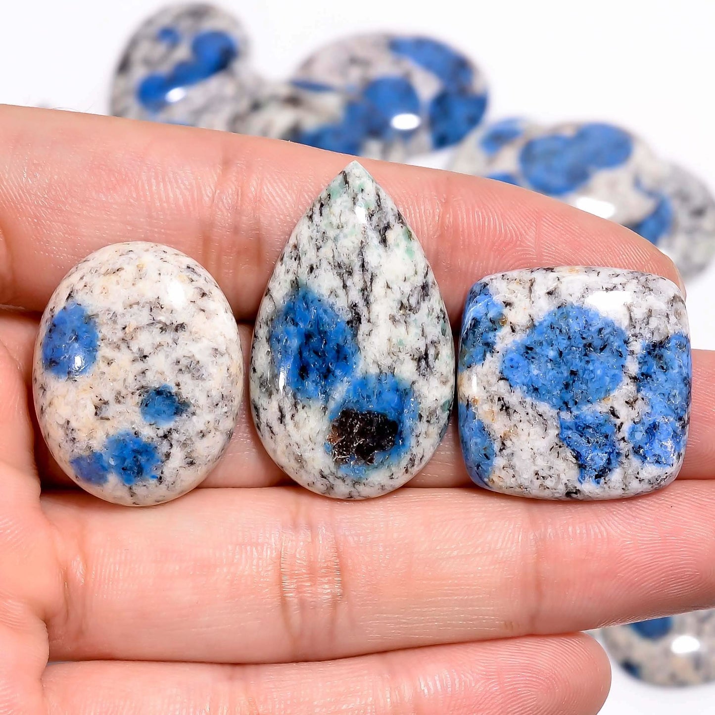 K2 jasper gemstone showing natural azurite blue spots on white granite
