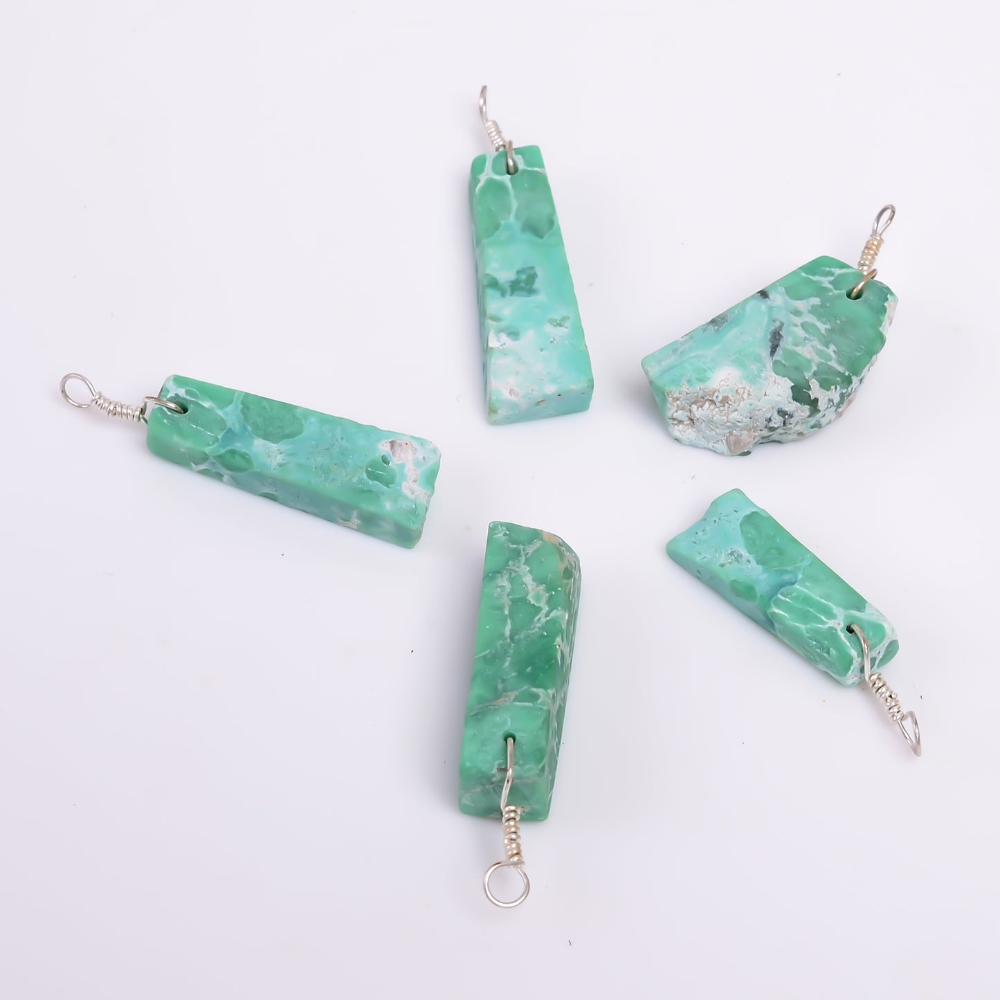 Natural variscite raw stone pendant photographed on a white background with green gemstone patterns and silver-plated finish