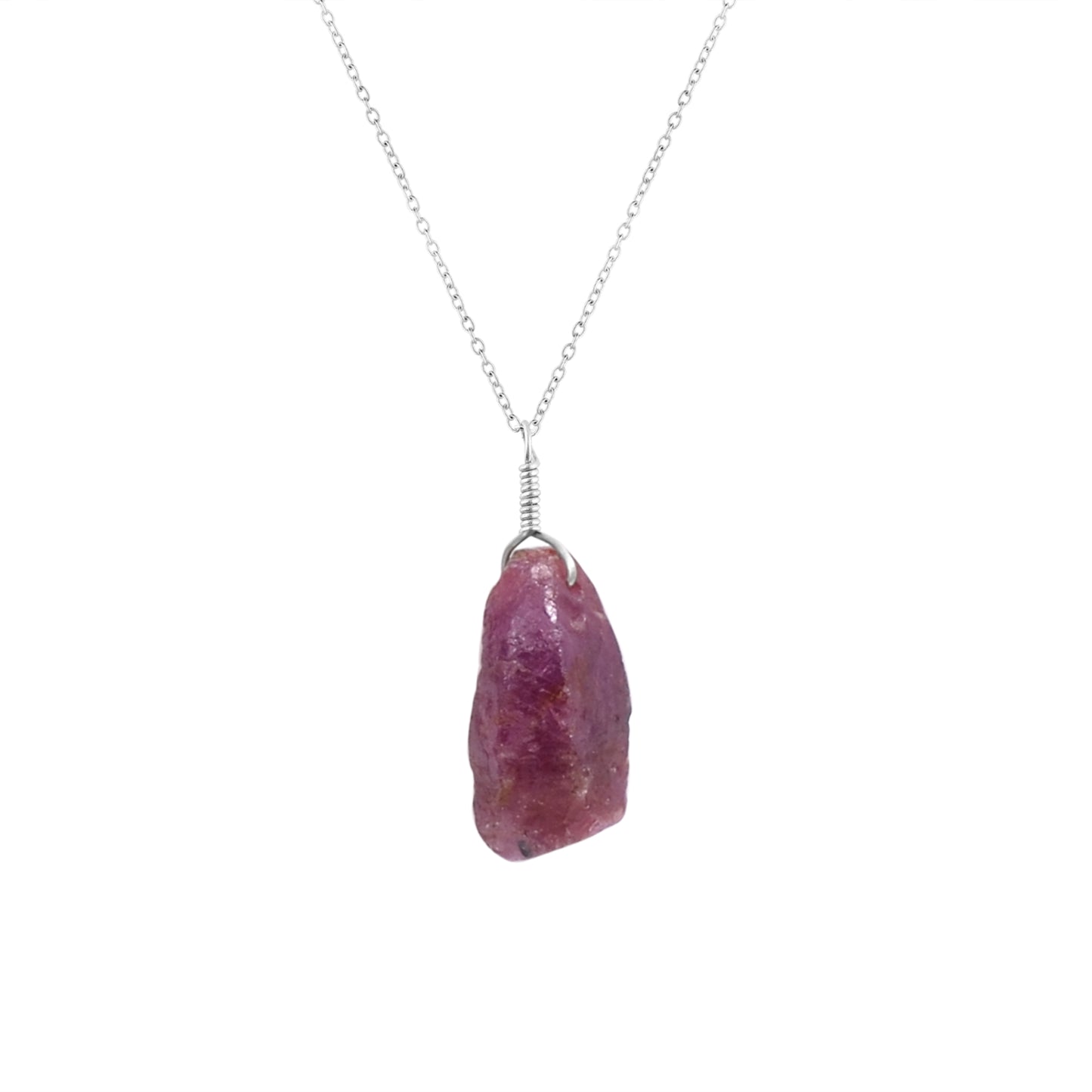 Close-up view of a natural raw ruby crystal pendant on an 18-inch silver-plated chain showcasing vivid pink gemstone