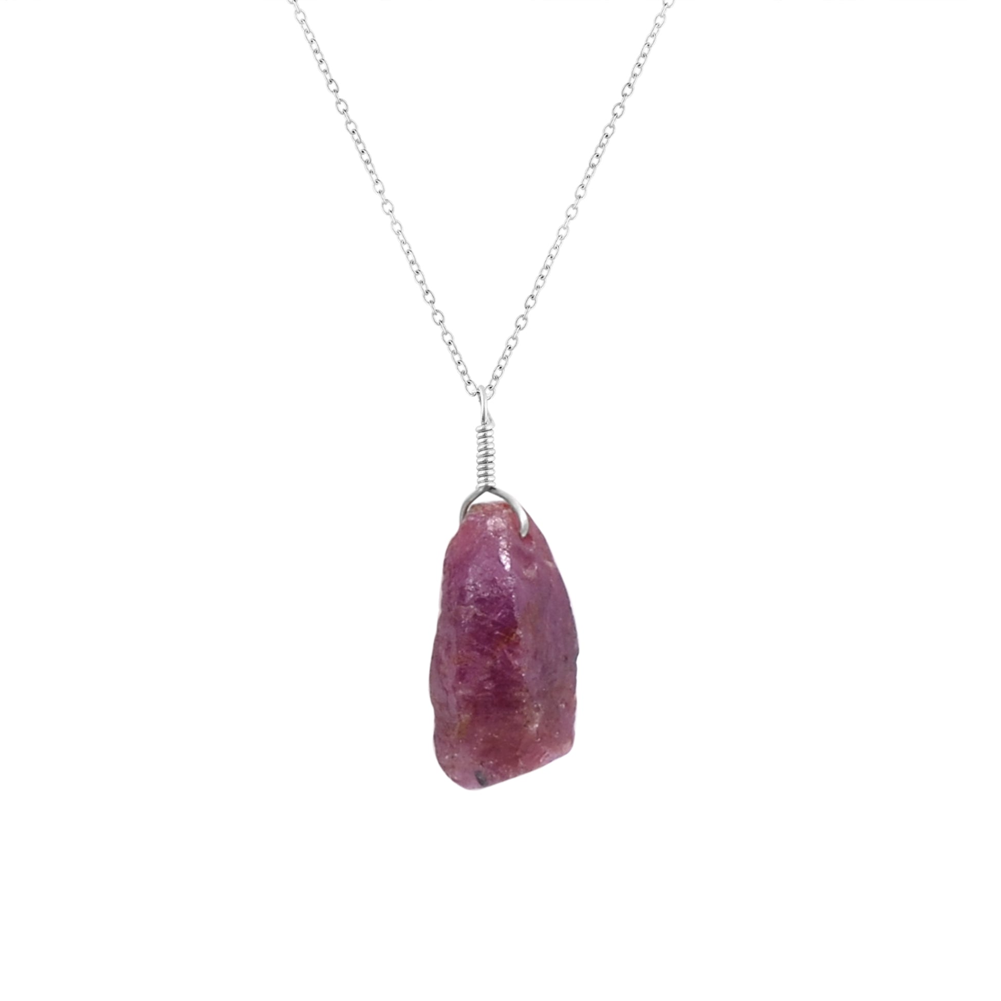 Close-up view of a natural raw ruby crystal pendant on an 18-inch silver-plated chain showcasing vivid pink gemstone