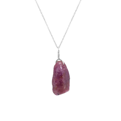 Close-up view of a natural raw ruby crystal pendant on an 18-inch silver-plated chain showcasing vivid pink gemstone