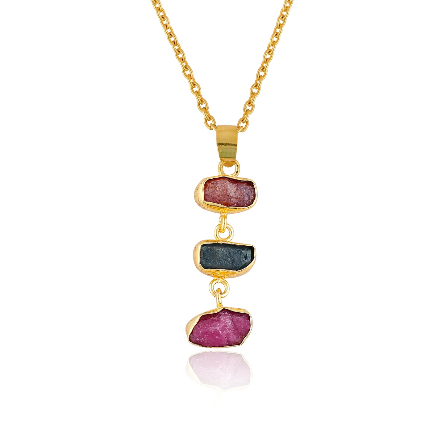 Raw sapphire and ruby crystal pendant necklace in gold-plated bezel displayed on white background showing vibrant blue and pink gemstones