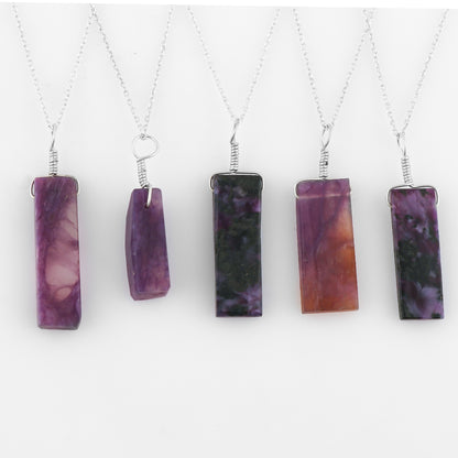 Five necklaces with purple stone pendants on a white background