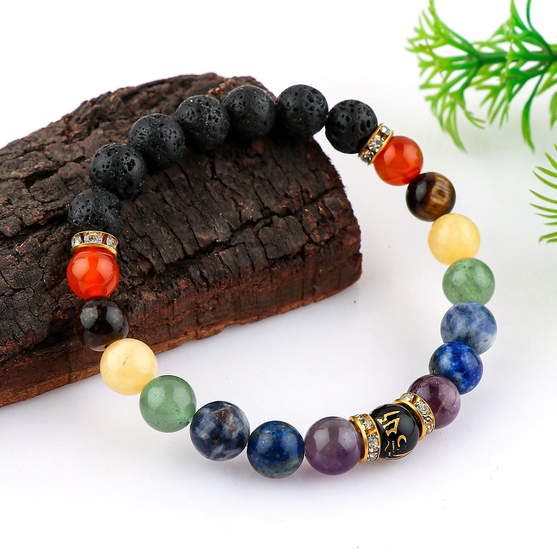 Multicolored beaded bracelet on a wooden surface with green leaves in the background