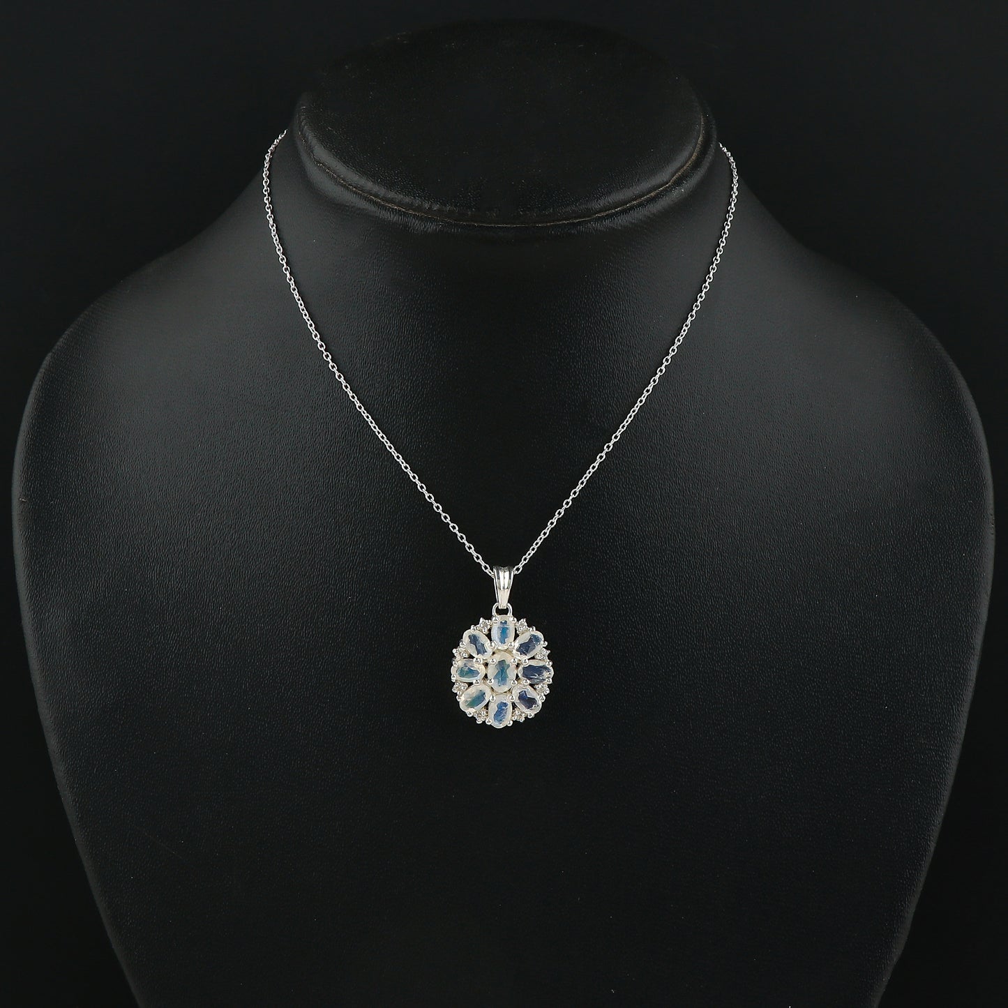 Silver necklace with a pendant on a black mannequin bust