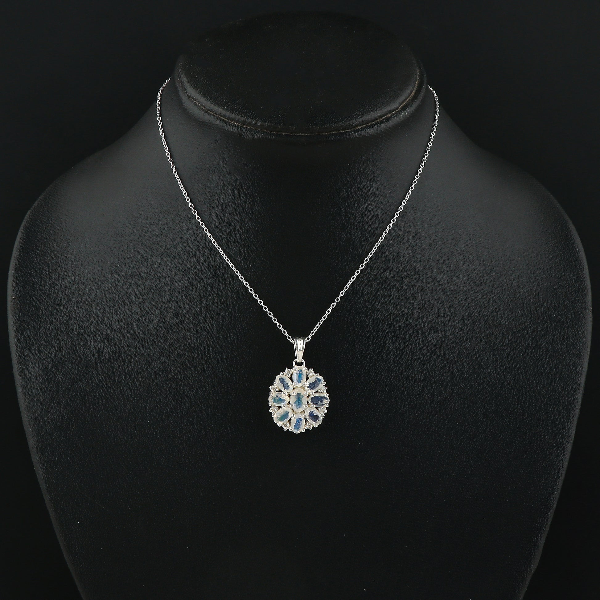 Silver necklace with a pendant on a black mannequin bust