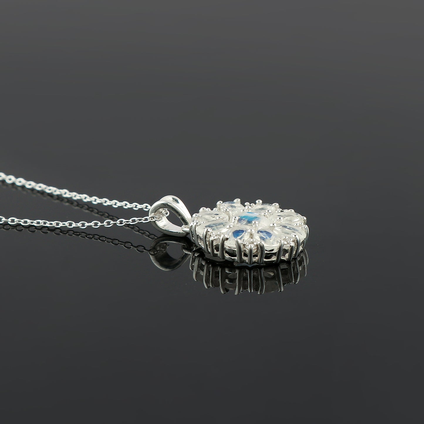 Silver pendant necklace on a black background