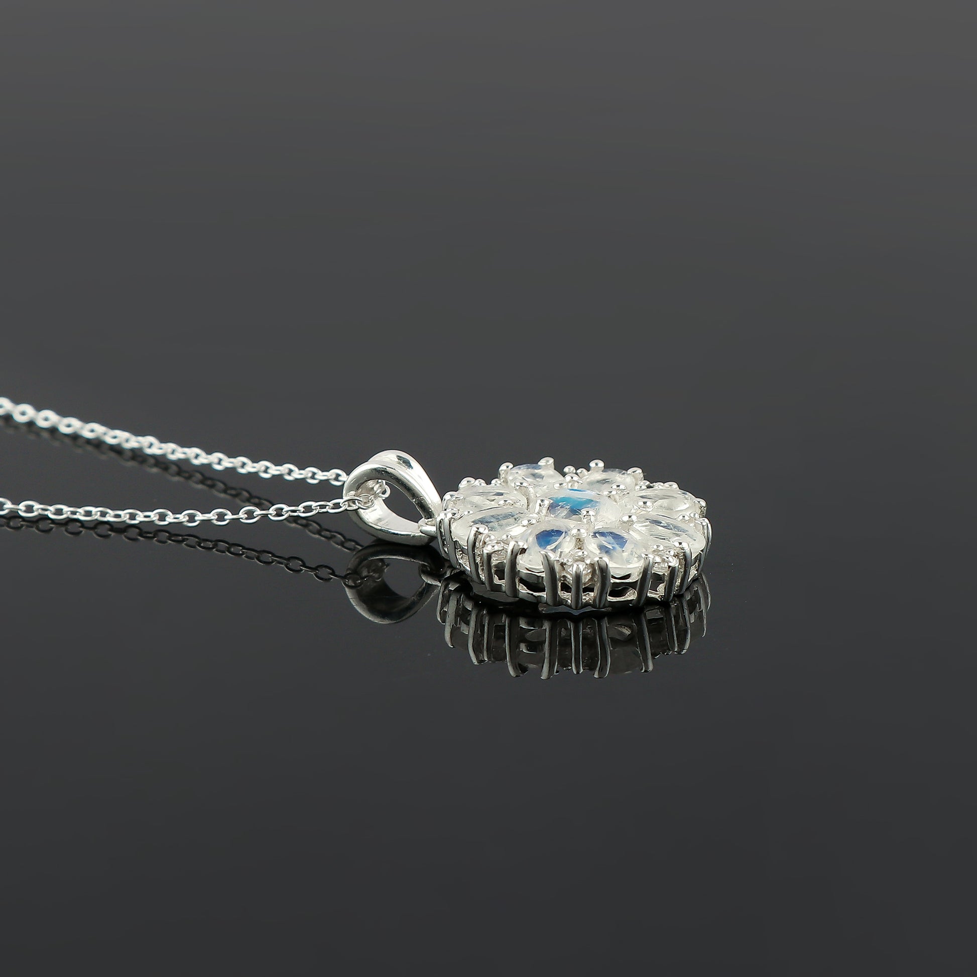 Silver pendant necklace on a black background