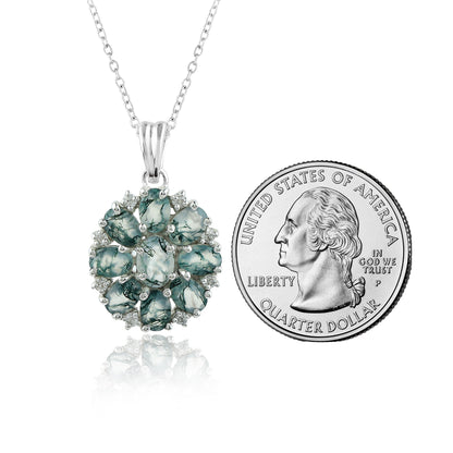 Green gemstone pendant with chain next to a U.S. quarter dollar coin for size comparison on a white background.