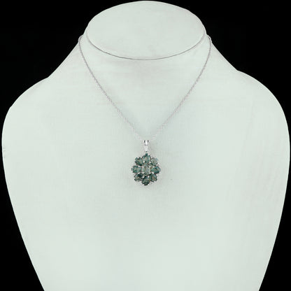 Green gemstone necklace on a mannequin with a black background
