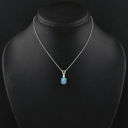 Silver necklace with a blue pendant on a black mannequin bust