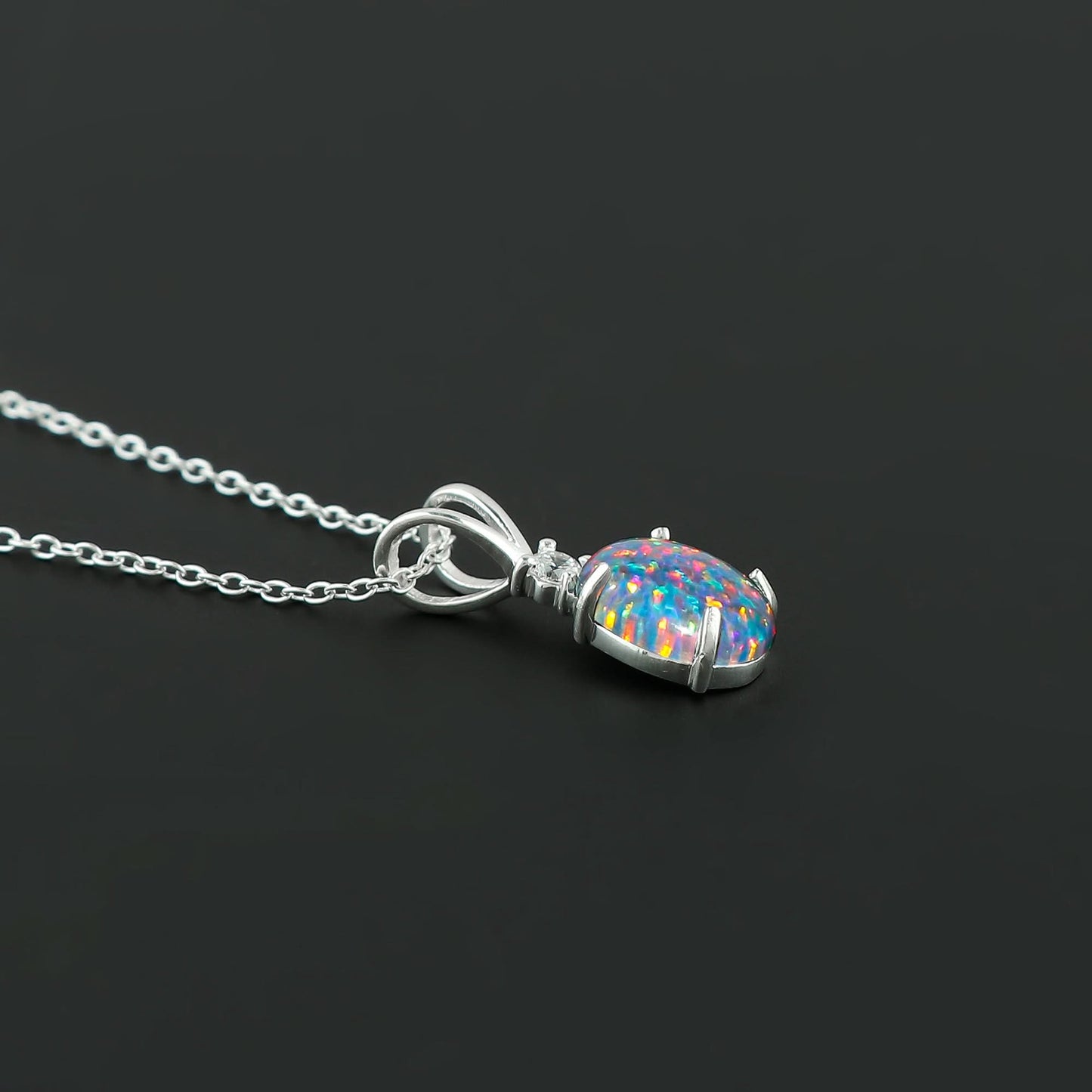 Necklace with a colorful opal pendant on a black background