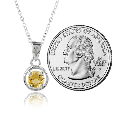 Yellow gemstone pendant on a chain next to a U.S. quarter dollar coin