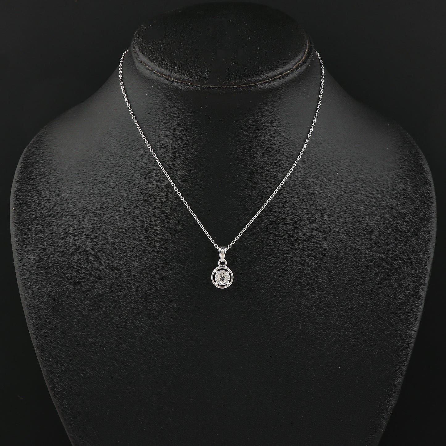 Silver necklace with a pendant on a black mannequin bust