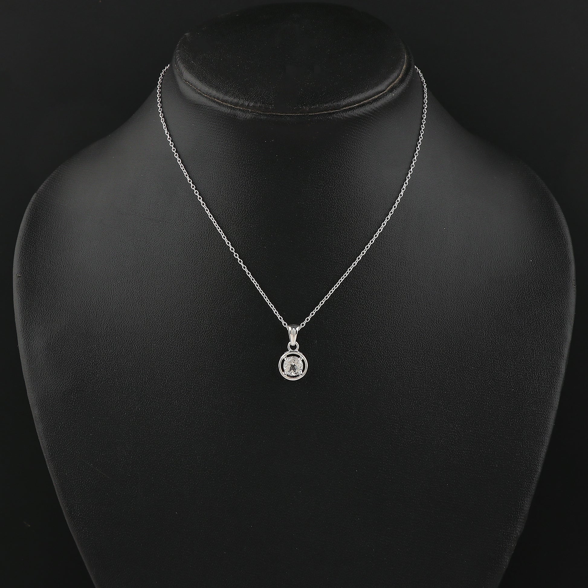 Silver necklace with a pendant on a black mannequin bust