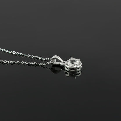 Silver necklace with a pendant on a black background
