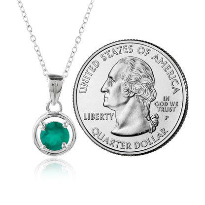 Green gemstone pendant on a chain next to a U.S. quarter dollar coin
