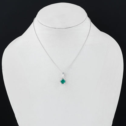 Silver necklace with a green gemstone pendant on a mannequin bust.