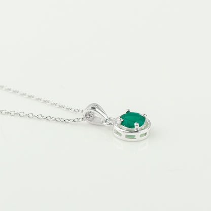 Silver necklace with a green gemstone pendant on a white background