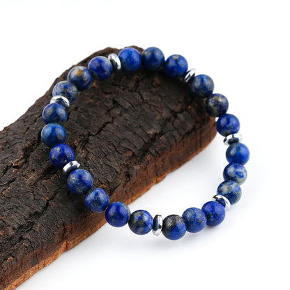 Lapis Lazuli Blue beaded bracelet with silver accents on a wooden block