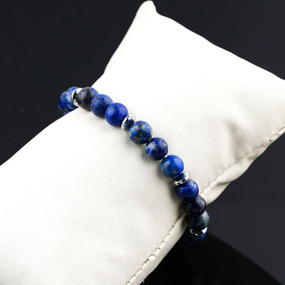 Lapis Lazuli Blue beaded bracelet on a white cushion with a black background