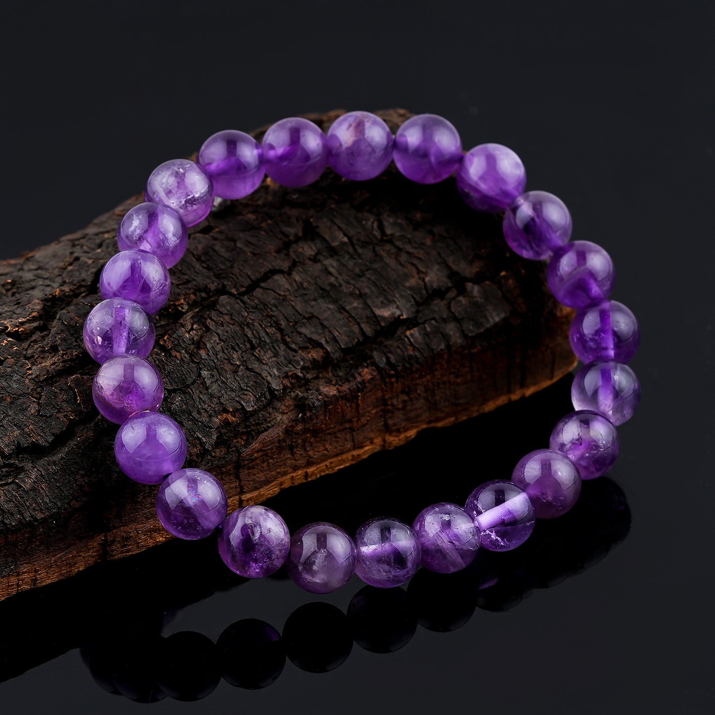 Amethyst  Purple beaded bracelet on a dark wooden surface