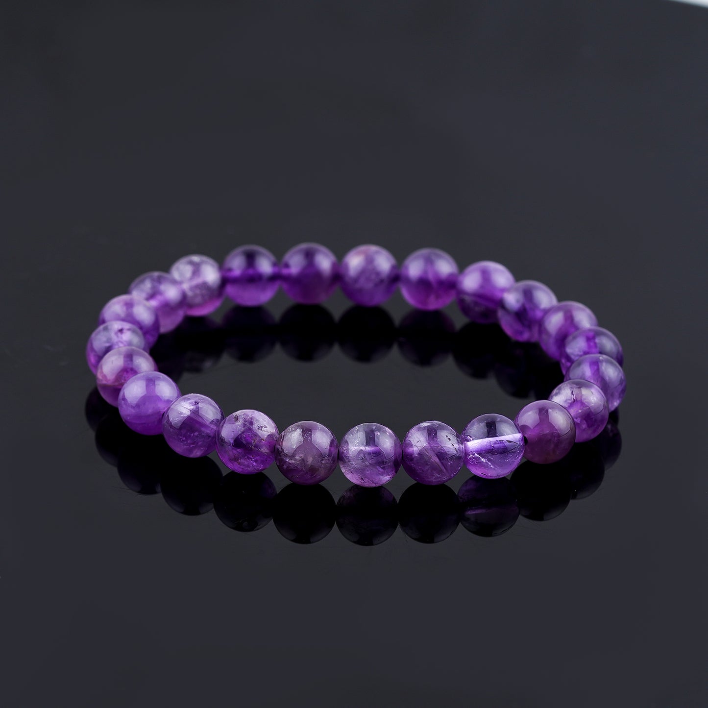Purple beaded bracelet on a black reflective surface