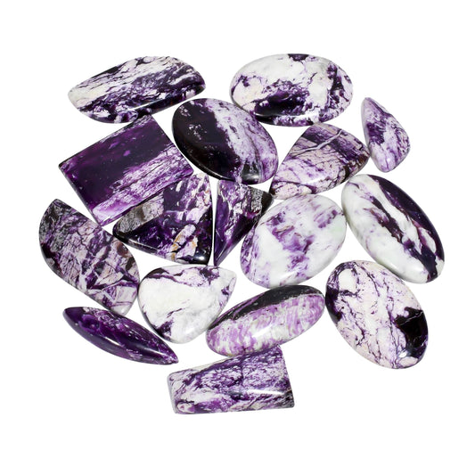 Polished kammererite stone cabochons with deep violet hues.