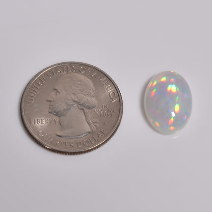6.00 carat white Ethiopian opal loose gemstone with vibrant color play, available at Armoniagems.
